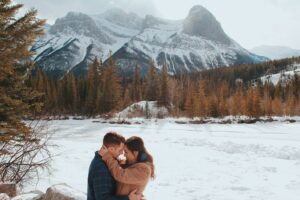 couple embracing in front of mountain view
