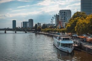 a river with a ferris wheel in the background