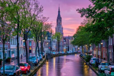 Canal with parked along cars in Delft town, Netherlands