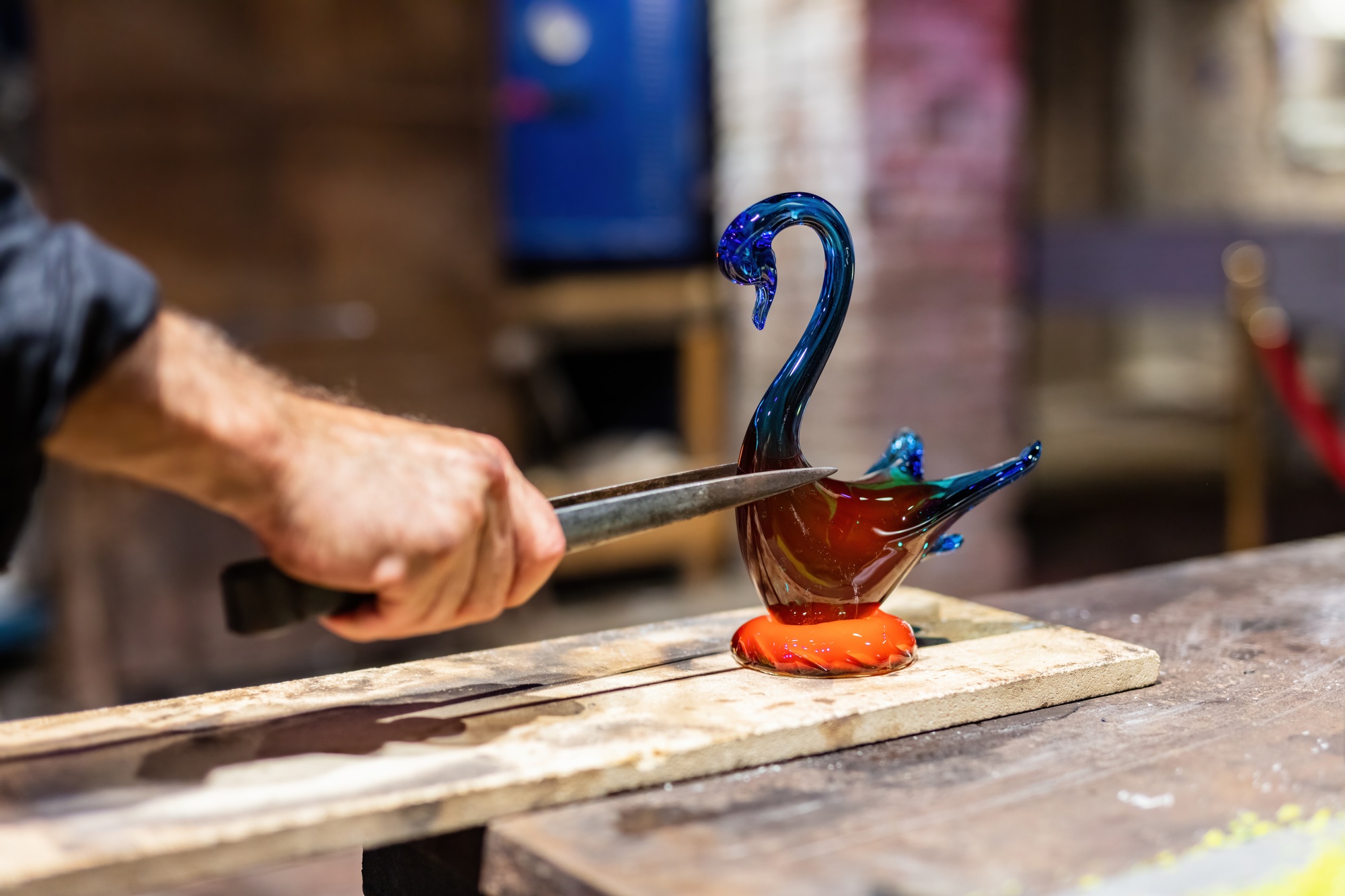 Glass blower at work in workshop in Murano, Italy