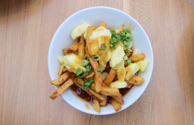 Poutine, top view of plated cheese curd and gravy over fries, Canada’s famous dish